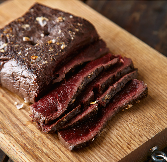 closeup-sliced-medium-rare-cooked-whale-meat-stake-wooden-table