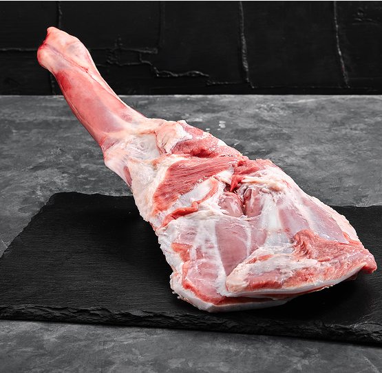 raw-lamb-leg-marble-cutting-board-dark-background-side-view